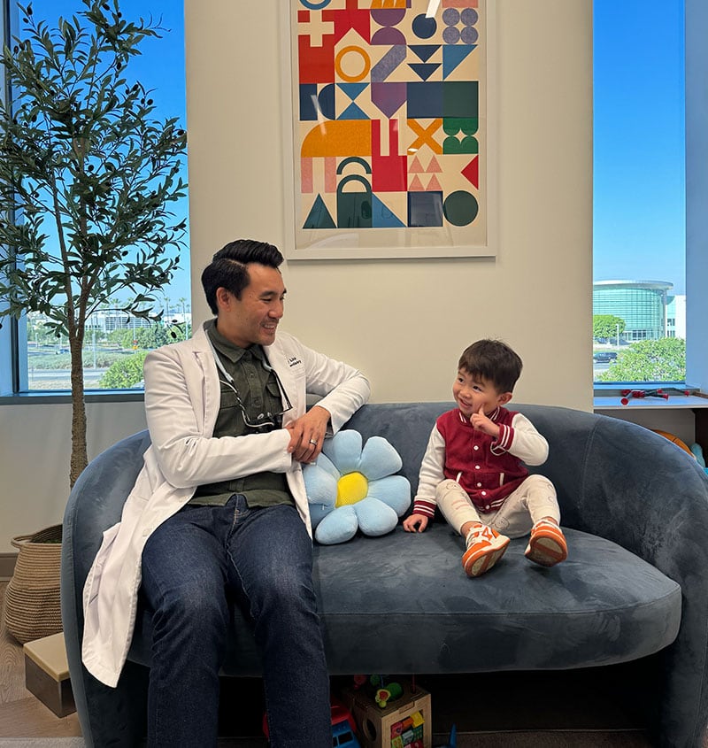 Orthodontist and smiling child talking during a consultation at Kind Smiles in Irvine