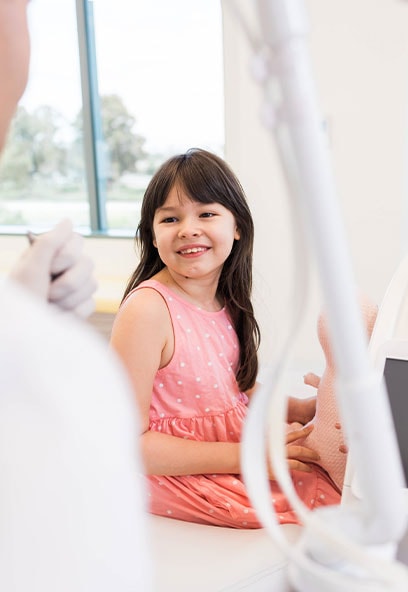 Young girl smiling during dental exam at Kind Smiles Irvine.